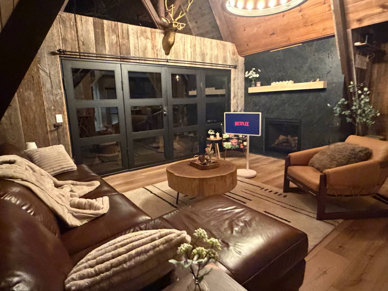 Living room with LG StanbyME TV, leather sofa, and fireplace